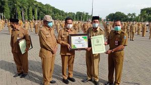 PENGHARGAAAN : Plt Bupati Gresik Dr. Mohammad Qosim saat memberikan penghargaan Adiwiyata tingkat Propinsi Jawa Timur pada sejumlah sekolah - Gresik Sabet 4 Penghargaan Adiwiyata Tingkat Propinsi Jawa Timur