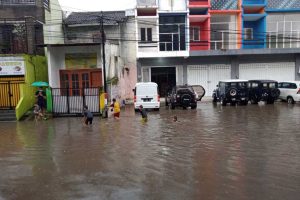 BANJIR : Anak-anak yang sedang bermain di Genangan Air yang ada di Jalan Kedawung, Kota Malang - Banjir di Kedawung Jadi Wisata Dadakan