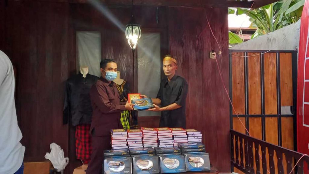 Kapolresta Banyuwangi Kombespol Arman Asmara Syarifuddin saat menyerahkan 100 Al-Qur'an dan 100 Sarung kepada keturunan Sulawesi, bertempat di sekretariat KSSS, Kelurahan Kampung Mandar, Jum'at (23/4/2021) siang - Kapolresta Banyuwangi Wakafkan 100 Al-Qur'an dan 100 Sarung Kepada KSSS