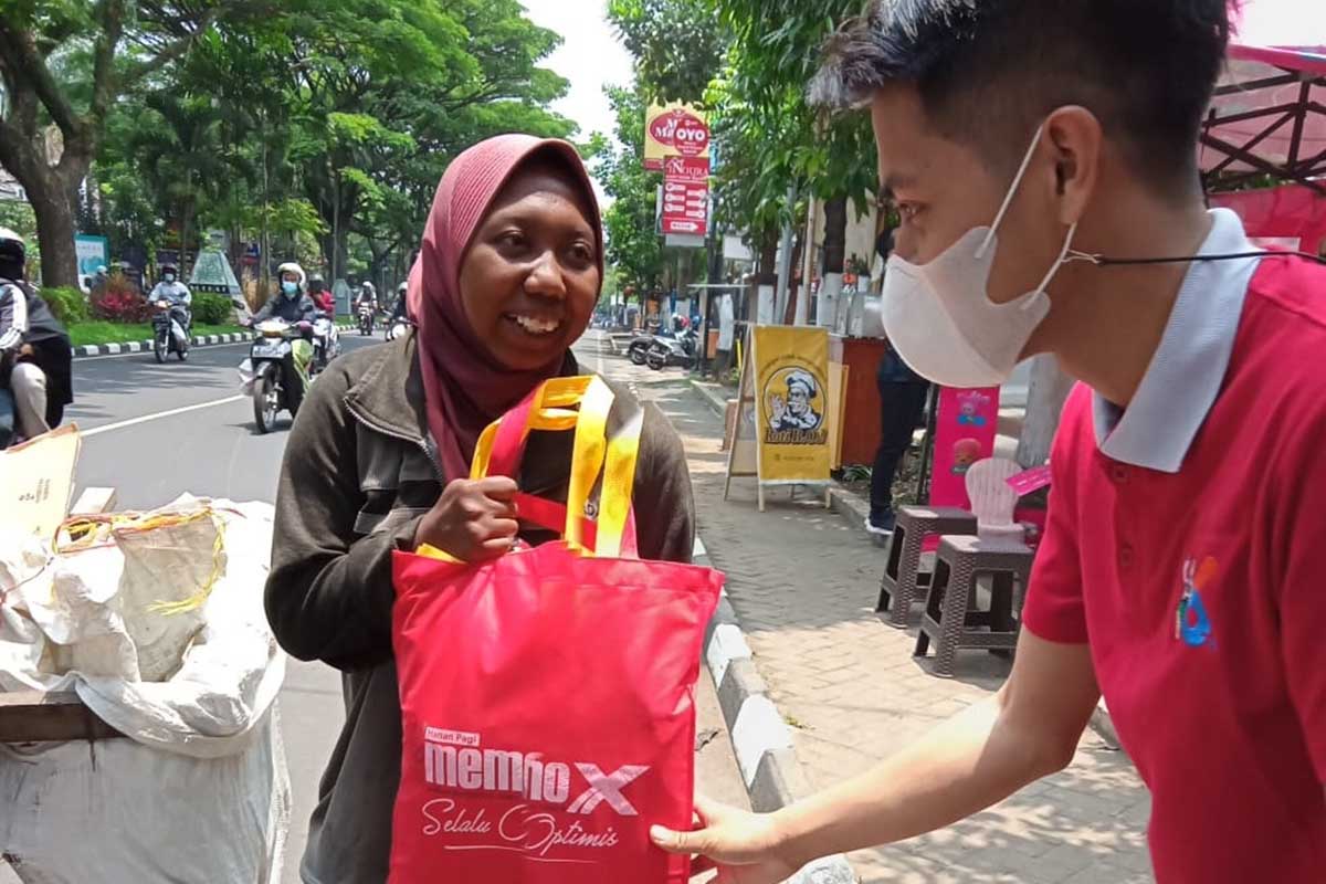 Tim berbagi pada pemulung yang mengais rejeki dari sampah. (jaz) - Rangkaian HUT ke-6 Memo X Grup Baksos Peduli Sesama