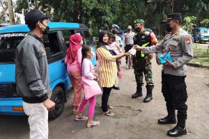 Petugas mensosialisasikan prokes dan membagikan masker kepada penumpang terminal Madyopuro. (ist) - Tim Pamor Keris Kedungkandang Masif Sisir Beberapa Lokasi