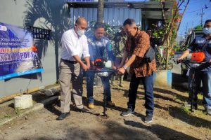 Simbolis penggalian tanah untuk penanaman biopori. (rhd) - Baksos Polinema Berikan Biopori, Rambu Lantas dan Renovasi Masjid