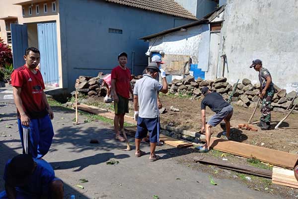 Babinsa Buring bersama warga gotong royong bersihkan saluran air. (ist) - Babinsa Buring Bersama Warga Gotong Royong Bersihkan Saluran Air