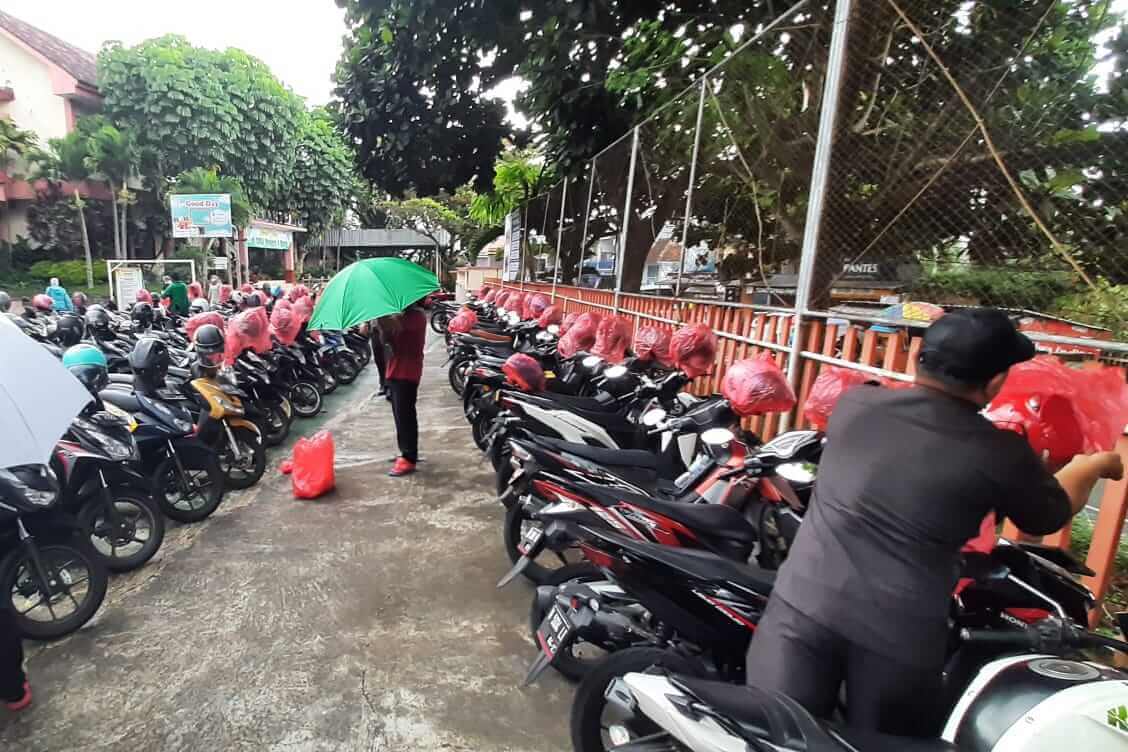aksi sigap jukir smansa batu amankan helm saat turun hujan tiba tiba