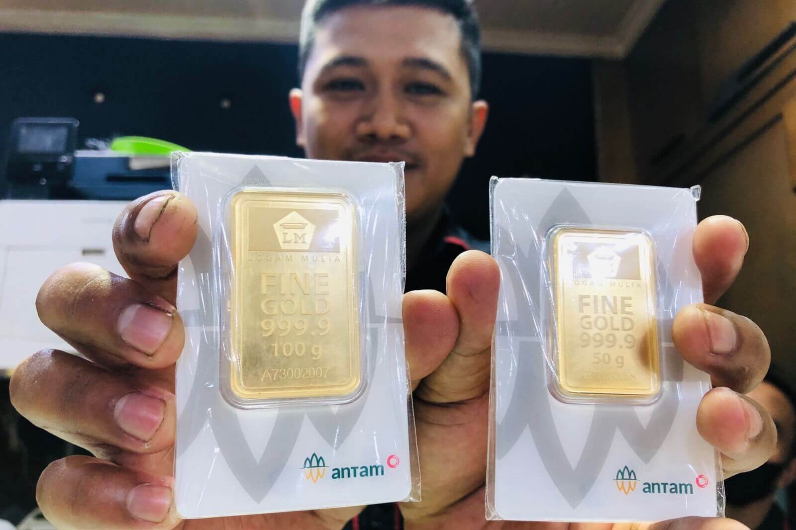 staf toko emas bulan purnama pasar besar kota malang helmi alif yustiansah tengah memegang logam mulia