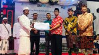 Penyerahan secara simbolis Rsi Yadnya kepada pemangku Pura Sambi Agung Sapto Argo. (wul) - BUMN Gelar Dharma Santi di Enam Lokasi di Indonesia Bersama antara Umat Agama