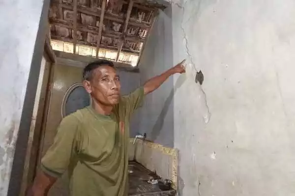 pupus menunjukkan retakan pada dinding rumahnya. (jup) - Hanya 12 KK Korban Longsor yang Direlokasi