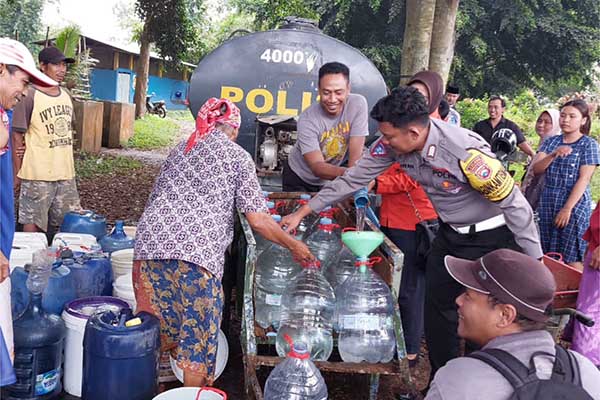 Pendistribusiam air bersih ke penduduk Desa Dengkol, Kecamatan Singosari, oleh Polres Malang. (ist) - Tandon Air Hipam Diperbaiki, Warga Dengkol Didropping Air Bersih oleh Polres Malang