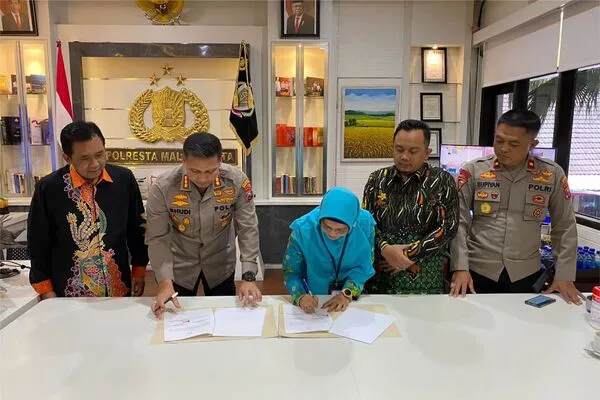 Kapolresta Malang Kota, Kombes Pol Budi Hermanto dan Ketua KPU kota Malang, Aminah Asminingtyas, menandatangi berkas Mou. (ist) - Sukseskan Pemilu 2024, Polresta Makota dan KPU Kota Malang Tandatangani MoU