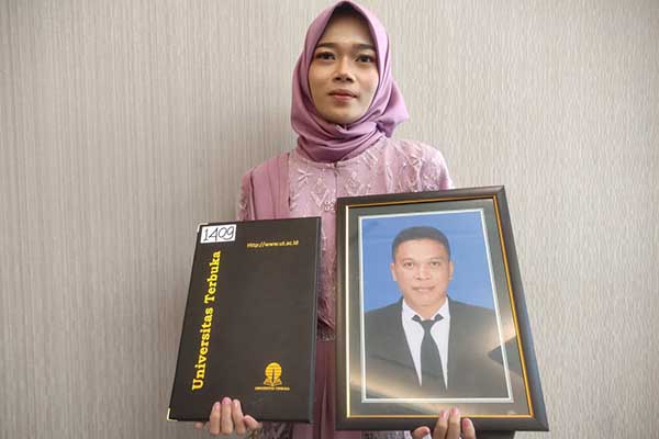 Ferda istri Rubiyanto, mewakili suami diwisuda. (rhd) - Universitas Terbuka Malang Wisuda 1.612 Mahasiswa, Satu Mendiang Wisudawan Diwakili Istri