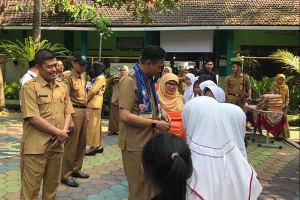 Pj Wali Kota Malang, Wahyu Hidayat bagi-bagi seragam. (ist) - Kunjungi SDN Bareng 3, Pj Walikota Nostalgia Masa Kecil