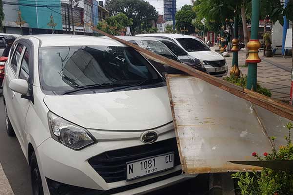 Kondisi R4 tertimpa papan reklame roboh karena angin kencang. (ist) - Babinsa Koramil Klojen Turut Evakuasi Papan Reklame Roboh Timpa R4