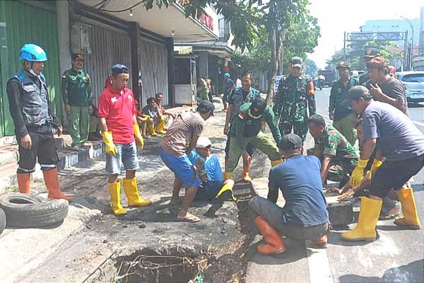 Babinsa Klojen bersama masyarakat Sukoharjo turut gerakan angkat sampah dan sedimen. (ist) - Babinsa Klojen Bersama Masyarakat Sukoharjo Turut Gerakan Angkat Sampah dan Sedimen