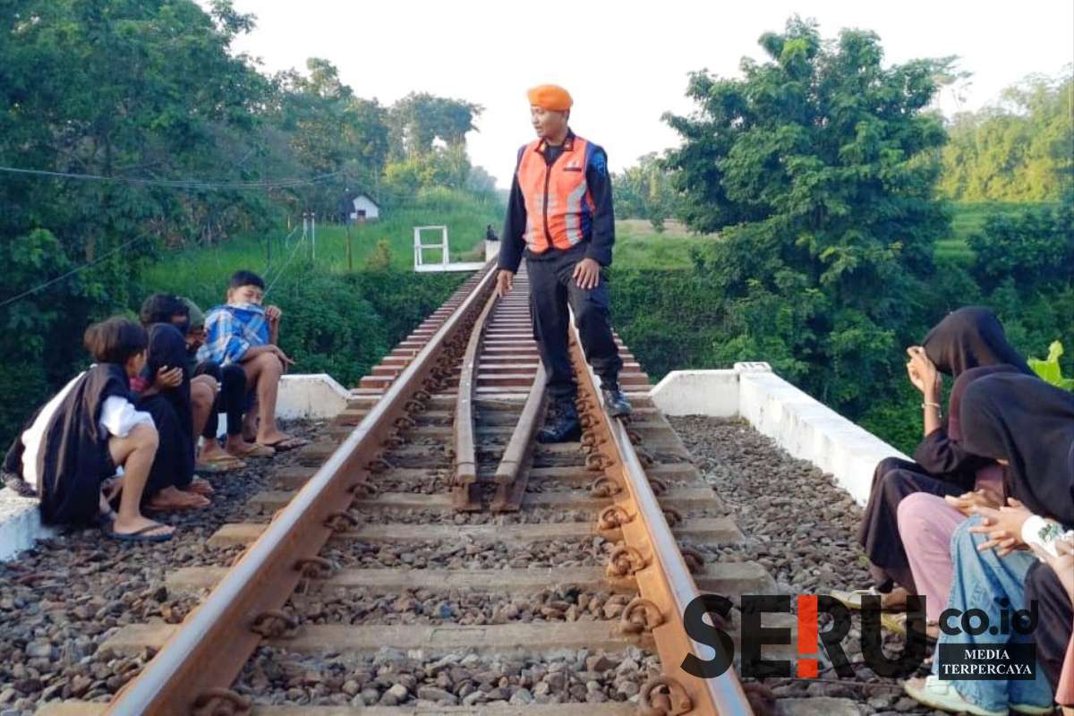 Petugas Polsuska Daop 8 Surabaya membubarkan dan memberikan sosialisasi kepada masyarakat di KM 13 petak jalan antara Stasiun Wonokerto-Sukorejo. (KAI Daop 8 for SERU.co.id) - KAI Larang Ngabuburit di Jalur Kereta Api, Pelanggar Bisa Dipidana