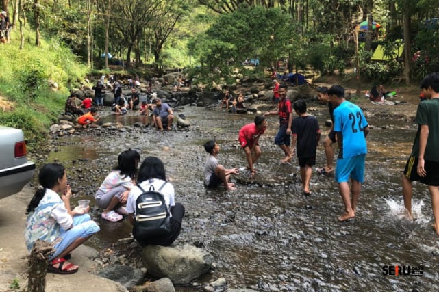 Para pengunjung bermain air di Bumi Perkemahan Bedengan Dau. (wul)